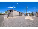 Mobile home with carport and gravel driveway at 9310 E Main St # 182, Mesa, AZ 85207