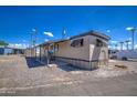 Mobile home with carport and gravel driveway at 9310 E Main St # 182, Mesa, AZ 85207