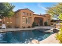 Luxury home with inviting pool, expansive patio, and outdoor kitchen at 9630 E Mountain Spring Rd, Scottsdale, AZ 85255