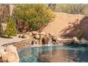 Serene waterfall feature flows into a refreshing pool at 9630 E Mountain Spring Rd, Scottsdale, AZ 85255