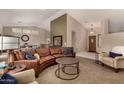 Spacious living room featuring a curved leather sofa and a neutral color palette at 10329 E Sunridge Dr, Sun Lakes, AZ 85248