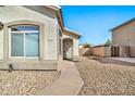 Front entrance with a teal door and stone pathway at 10932 W Morten Ave, Glendale, AZ 85307