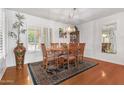 Bright dining room with hardwood floors and a charming chandelier at 12059 S Paiute St, Phoenix, AZ 85044