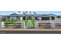 Modern home exterior with a gray roof, white walls, and a paved driveway at 12075 N 76Th Ct, Scottsdale, AZ 85260