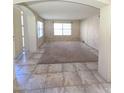 Living room with tile flooring and neutral carpeting at 12419 W Monte Vista Rd, Avondale, AZ 85392