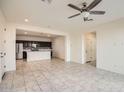 Open living area with tile floors and a view of the kitchen at 14238 W Bronco Trl, Surprise, AZ 85387