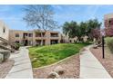 Two-story condo building with grassy courtyard and walkways at 14645 N Fountain Hills Blvd # 217, Fountain Hills, AZ 85268