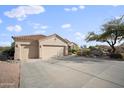 Two-car garage with a long driveway and desert landscape at 15020 E Sierra Madre Dr, Fountain Hills, AZ 85268