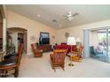 Living room with open floor plan, showcasing a view of the kitchen and access to a patio at 16549 W Desert Ln, Surprise, AZ 85388