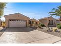 Two-car garage and desert landscaping with cactus plants at 16935 W Villagio Dr, Surprise, AZ 85387