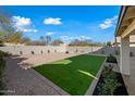 Landscaped backyard with artificial turf and a spacious area for entertaining at 1744 W Encinas St, Gilbert, AZ 85233