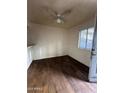 Bedroom with wood-look flooring, a ceiling fan, and a window at 18202 N Cave Creek Rd # 108, Phoenix, AZ 85032