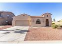 Tan colored house with a two car garage and rock landscaping at 18970 N Alicante St, Maricopa, AZ 85138