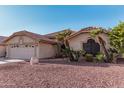 Single-story home with a two-car garage and desert landscaping at 19662 N 93Rd Dr, Peoria, AZ 85382