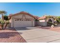 Two-car garage with desert landscaping and driveway at 19662 N 93Rd Dr, Peoria, AZ 85382