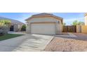 Front view of a tan house with a two-car garage at 20234 N 71St Ln, Glendale, AZ 85308