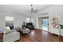 Living room with hardwood floors, a comfy couch, and access to a patio at 20234 N 71St Ln, Glendale, AZ 85308