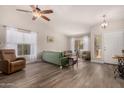 Living room features wood-look floors, a green couch and comfortable seating at 20838 N 101St Dr, Peoria, AZ 85382