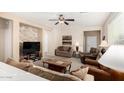 Cozy living room featuring a stone accent wall and comfortable seating at 21816 N 261St Ave, Buckeye, AZ 85396