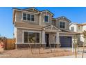 Two-story house with a gray exterior, blue garage door, and landscaping at 23472 S 210Th St, Queen Creek, AZ 85142