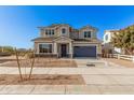 Two-story house with a gray exterior, blue garage door, and landscaping at 23472 S 210Th St, Queen Creek, AZ 85142