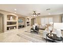 Open living room featuring built-in shelving and a large TV at 23618 W Adams St, Buckeye, AZ 85396