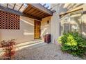 Front entry with terracotta accents and a wooden door at 26247 N El Prado --, Rio Verde, AZ 85263