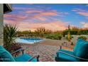 Relaxing patio with turquoise chairs overlooking a refreshing pool at 27931 N Montana Dr, Rio Verde, AZ 85263