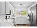 Bright kitchen featuring white shaker cabinets, quartz countertops, and stainless steel appliances at 2923 N 81St Pl, Scottsdale, AZ 85251