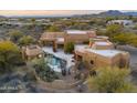 Aerial view of house with pool and desert landscaping at 30600 N Pima Rd # 63, Scottsdale, AZ 85266