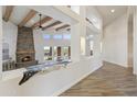 Open hallway view with wood beams and a stone fireplace at 30600 N Pima Rd # 63, Scottsdale, AZ 85266