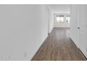 Bright hallway with wood-look tile flooring leading to other rooms at 35810 N 138Th St, Scottsdale, AZ 85262