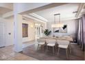 Bright dining room with a large table and modern light fixture at 3731 E Fruitvale Ave, Gilbert, AZ 85297