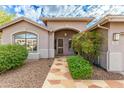 Front entry with a stone walkway and mature shrubs at 4543 E Molly Ln, Cave Creek, AZ 85331