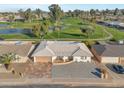 Home situated on a golf course with water features nearby at 4902 E Flossmoor Ave, Mesa, AZ 85206