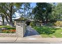 Landscaped front yard with mature trees and a long driveway leading to the home at 5160 N 45Th Pl, Phoenix, AZ 85018