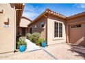 Inviting front entry with well-manicured landscaping, pavers, and a decorative door at 5626 E Sleepy Ranch Rd, Cave Creek, AZ 85331