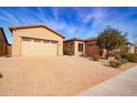 Tan house with a three-car garage and a brick driveway at 5626 E Sleepy Ranch Rd, Cave Creek, AZ 85331