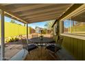 Covered patio with a table and chairs, ideal for outdoor dining and relaxation at 59 N Adams St, Wickenburg, AZ 85390