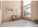 Bright sitting room with large windows, a bench, and framed artwork at 5902 W Gambit Trl, Phoenix, AZ 85083