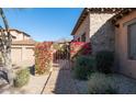 Inviting courtyard entry with a wrought iron gate and bougainvillea at 7701 E Golden Eagle E Cir, Gold Canyon, AZ 85118