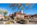 Beautiful stone exterior, lush landscaping, and a private courtyard at 7701 E Golden Eagle E Cir, Gold Canyon, AZ 85118