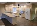 Galley-style kitchen with light wood cabinets and granite countertops at 8020 E Keats Ave # 314, Mesa, AZ 85209