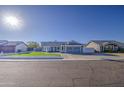 Front view of a single story house with artificial turf and driveway at 8021 W Charter Oak Rd, Peoria, AZ 85381