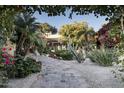 Stone pathway winding through a lush courtyard with fountain at 8408 E La Senda Dr, Scottsdale, AZ 85255