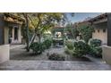 Inviting courtyard with a central fountain and lush greenery at 8408 E La Senda Dr, Scottsdale, AZ 85255