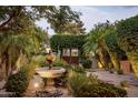 Charming courtyard entry with fountain and lush landscaping at 8408 E La Senda Dr, Scottsdale, AZ 85255