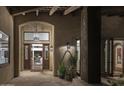 Elegant entryway with a large wooden door and ornate lighting at 8408 E La Senda Dr, Scottsdale, AZ 85255