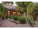 Spanish-style home with landscaped front yard, featuring a courtyard and pathway at 8408 E La Senda Dr, Scottsdale, AZ 85255