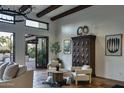 Living room features a large wood cabinet and access to the backyard at 8408 E La Senda Dr, Scottsdale, AZ 85255